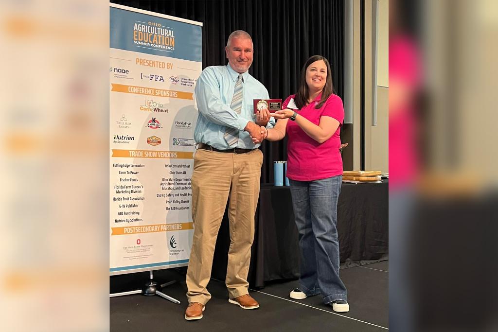 Alison Derringer, Agricultural Education instructor at Twin Valley South High School and past President of the Ohio Association of Agricultural Educators presents Edison State Director of Agriculture Program Brad Lentz with the OAAE award for Outstanding Postsecondary Agricultural Program at the OAAE summer conference.