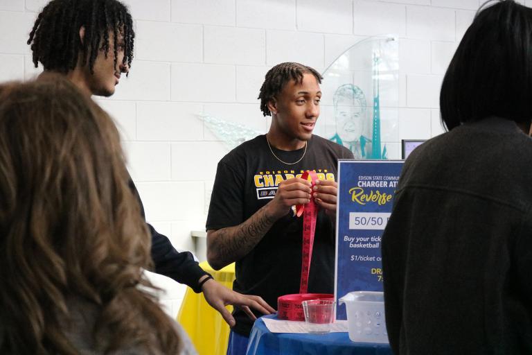 Student-athlete selling raffle tickets