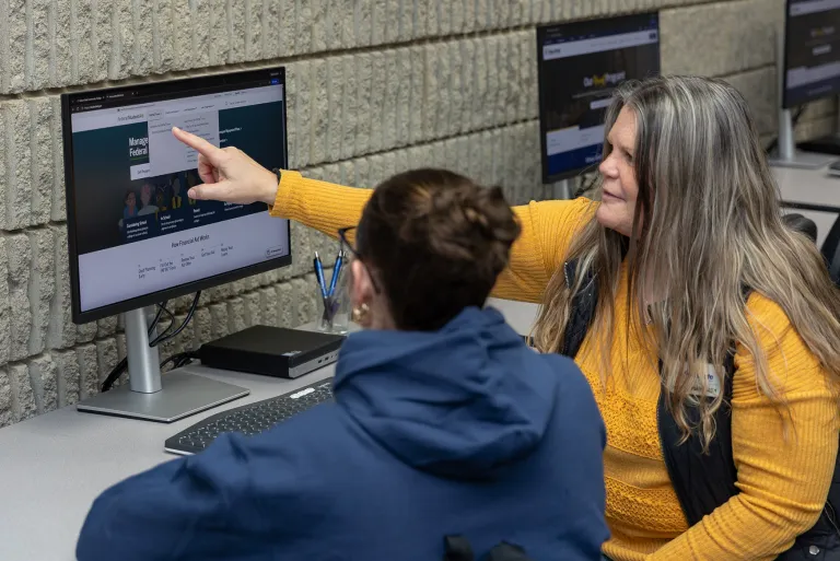 Financial Aid employee helping student