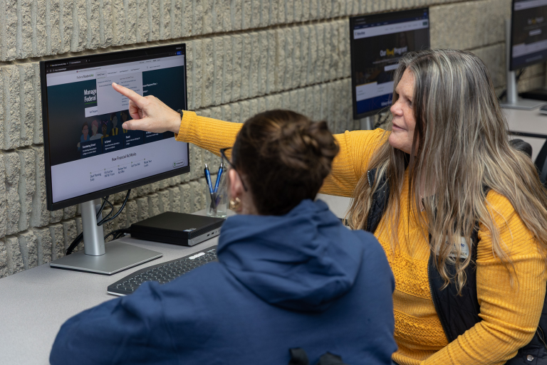Financial Aid employee helping student