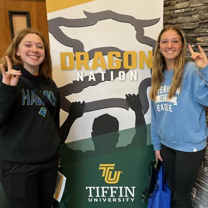 students in front of dragon nation banner
