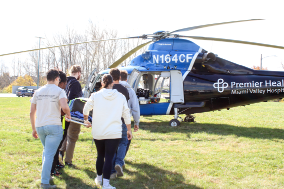 Edison State EMT students practice loading a stretcher onto a CareFlight helicopter.