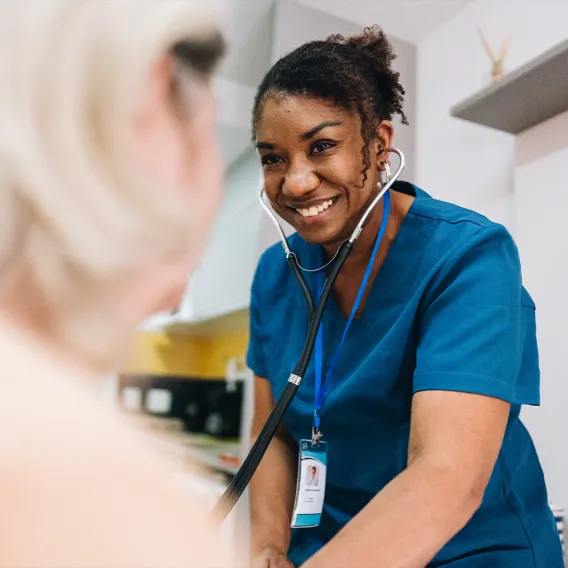 Nurse Checking On Elderly Patient