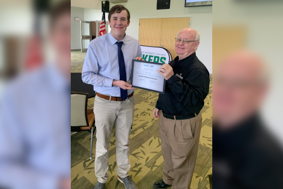 Noah Roy receives his scholarship award from Dr. Roger Fulk, a member of the WCOMP Selection Committee and Workforce Success Specialist at Edison State.