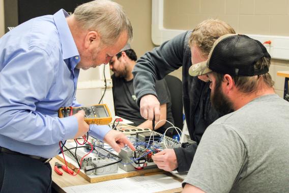 Industrial Technical Training Manager Keith Barga advises Jonathon W., of Cooper Farms (Fort Recovery), and Jason C., of Abbott Labs (Tipp City), during an Industrial Electrical Controls Fundamentals course at Edison State’s Piqua Campus.