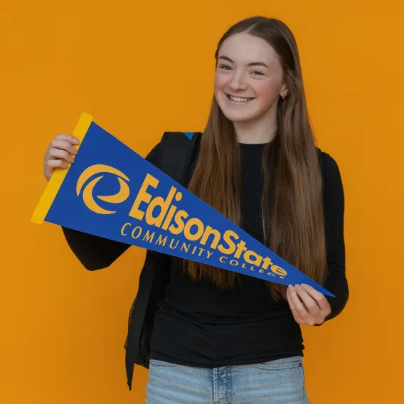 Edison State Student Holding Pennant Flag
