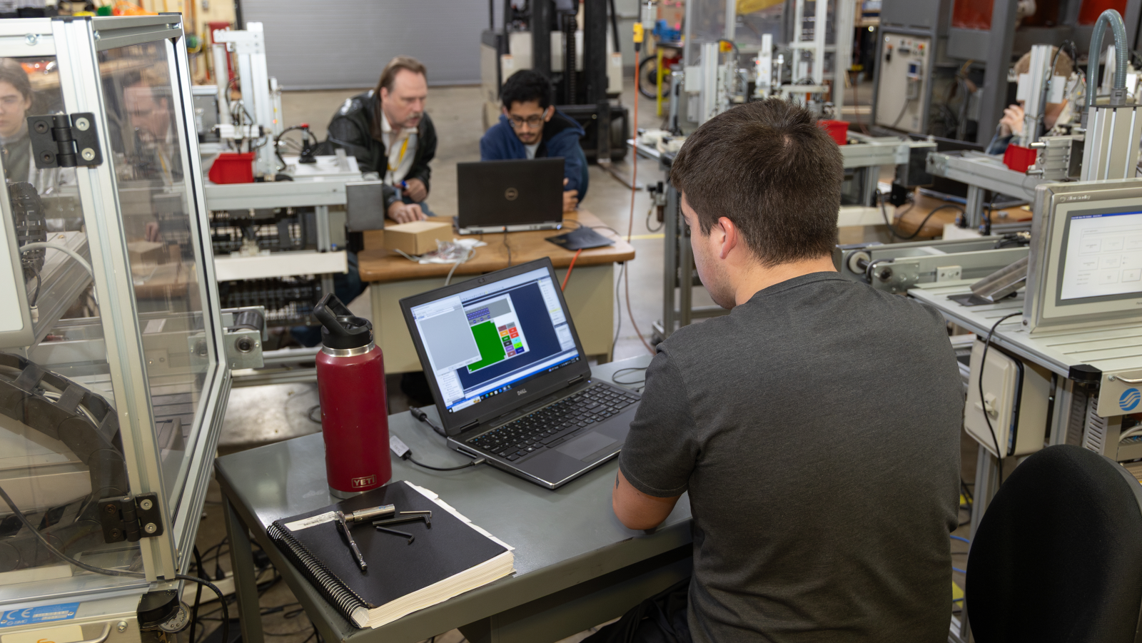 Electro-Mechanical Engineering Student working on computer program 
