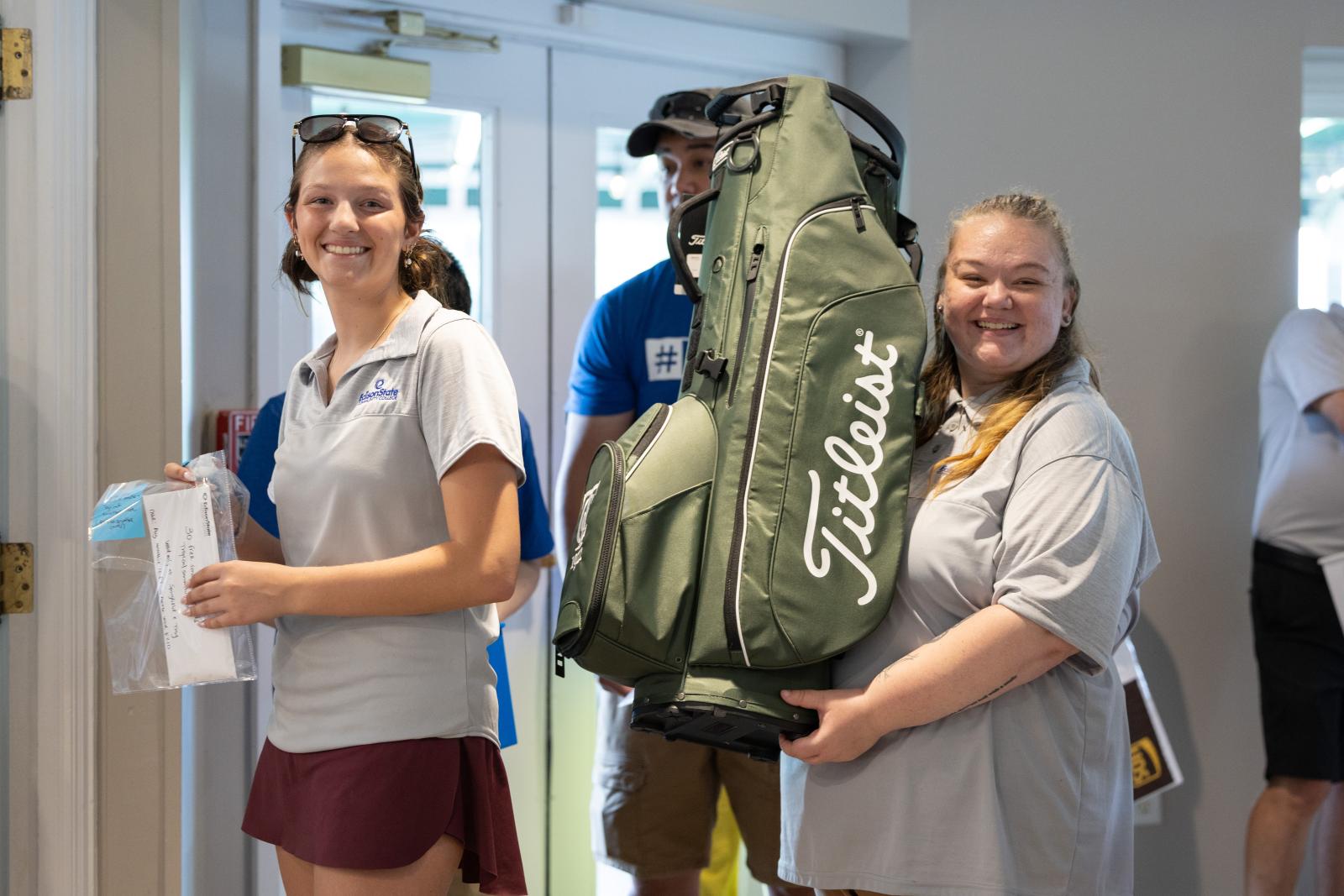 Edison State students holding raffle prizes